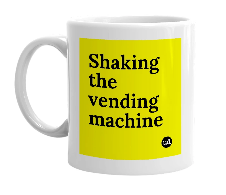 White mug with 'Shaking the vending machine' in bold black letters