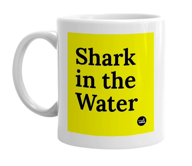 White mug with 'Shark in the Water' in bold black letters
