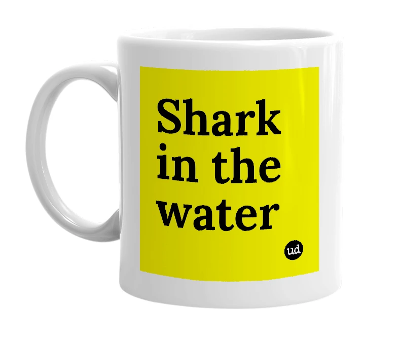 White mug with 'Shark in the water' in bold black letters