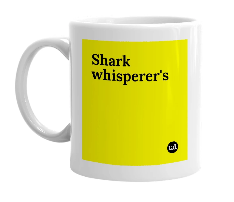 White mug with 'Shark whisperer's' in bold black letters