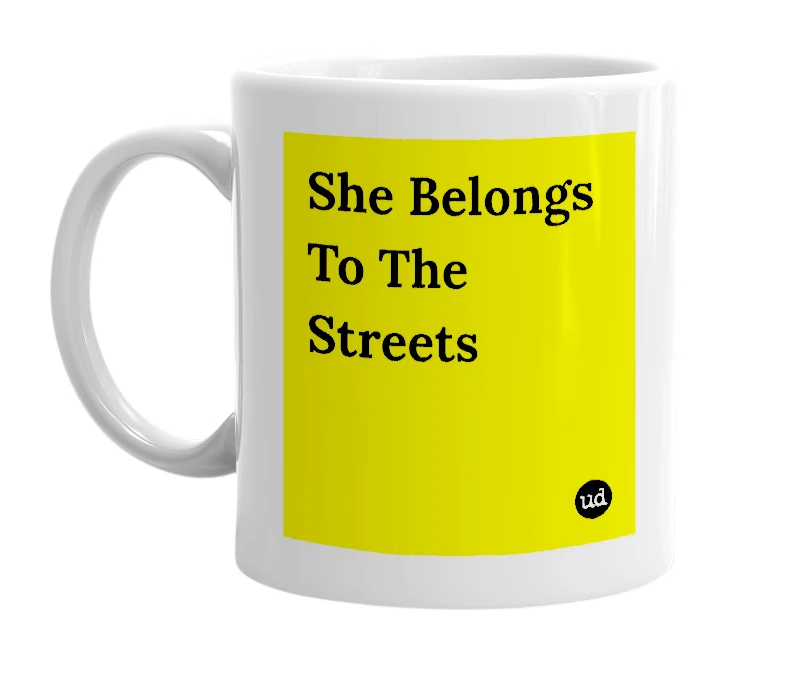 White mug with 'She Belongs To The Streets' in bold black letters