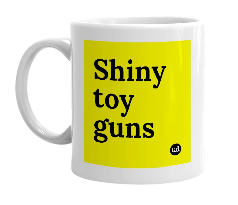 White mug with 'Shiny toy guns' in bold black letters
