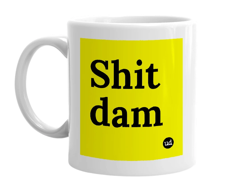 White mug with 'Shit dam' in bold black letters