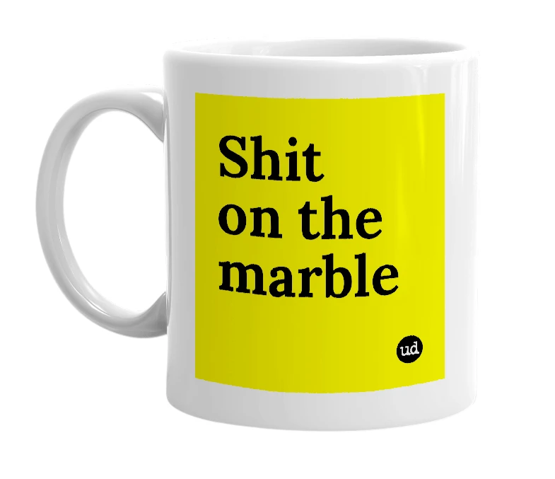 White mug with 'Shit on the marble' in bold black letters