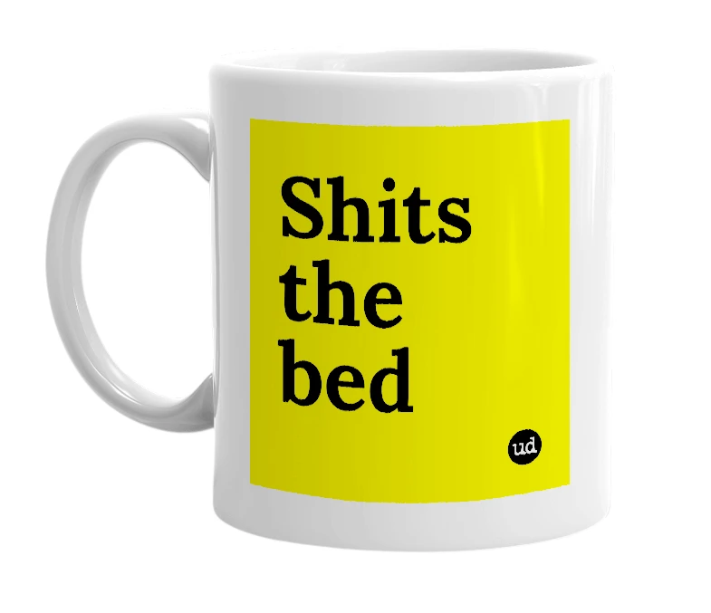 White mug with 'Shits the bed' in bold black letters