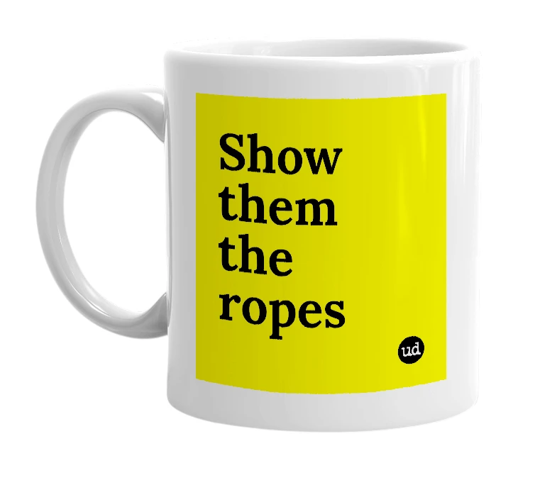 White mug with 'Show them the ropes' in bold black letters