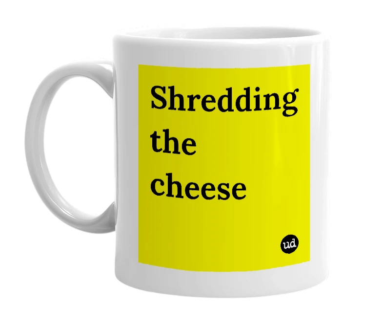 White mug with 'Shredding the cheese' in bold black letters