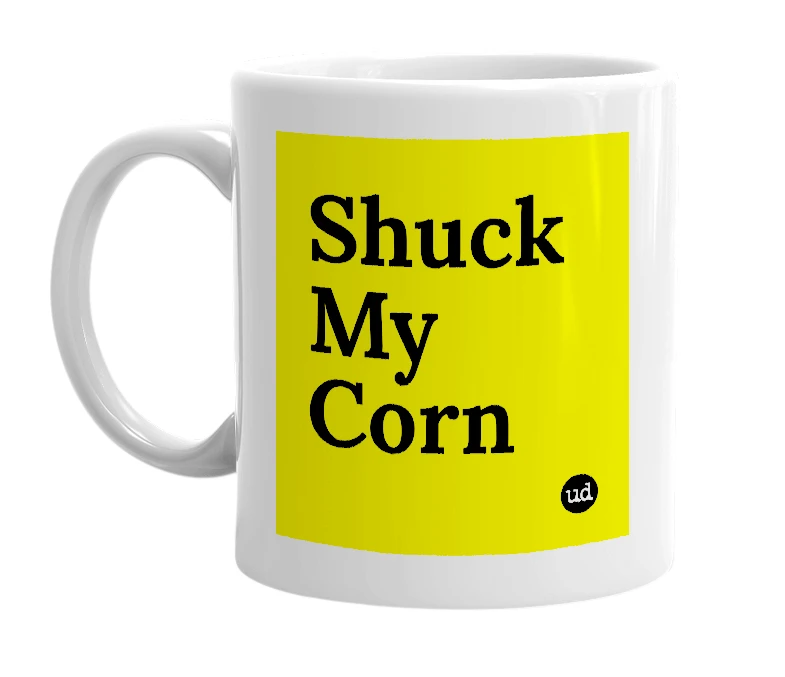 White mug with 'Shuck My Corn' in bold black letters