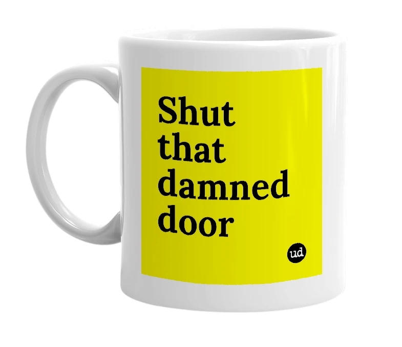 White mug with 'Shut that damned door' in bold black letters
