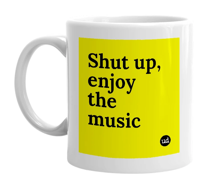 White mug with 'Shut up, enjoy the music' in bold black letters