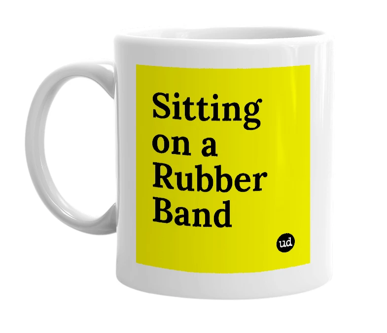 White mug with 'Sitting on a Rubber Band' in bold black letters