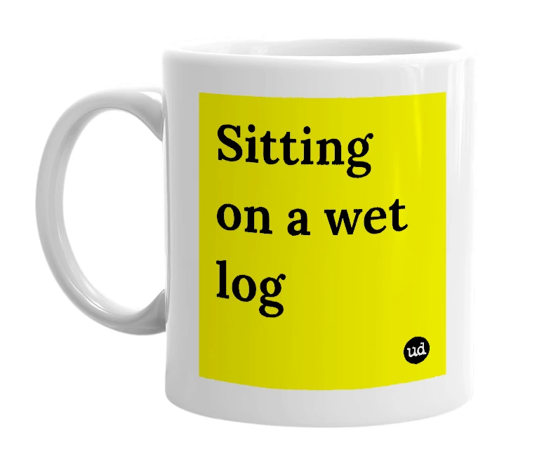 White mug with 'Sitting on a wet log' in bold black letters