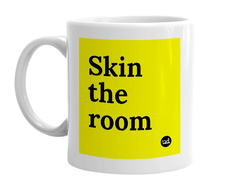 White mug with 'Skin the room' in bold black letters