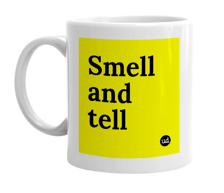 White mug with 'Smell and tell' in bold black letters