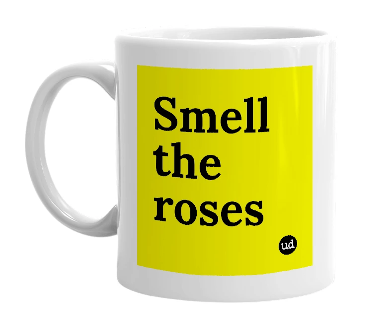 White mug with 'Smell the roses' in bold black letters