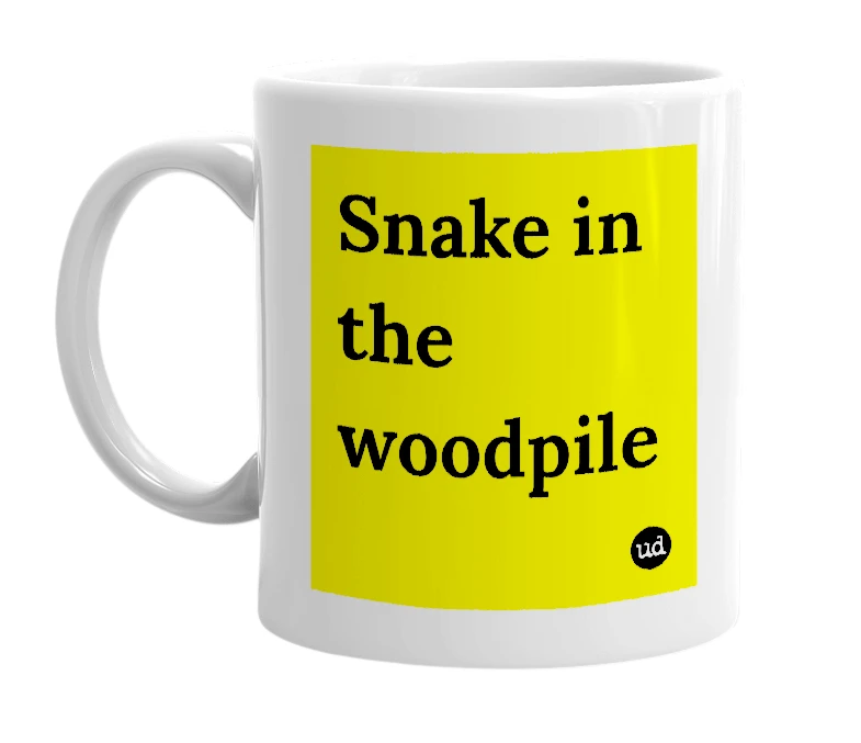 White mug with 'Snake in the woodpile' in bold black letters