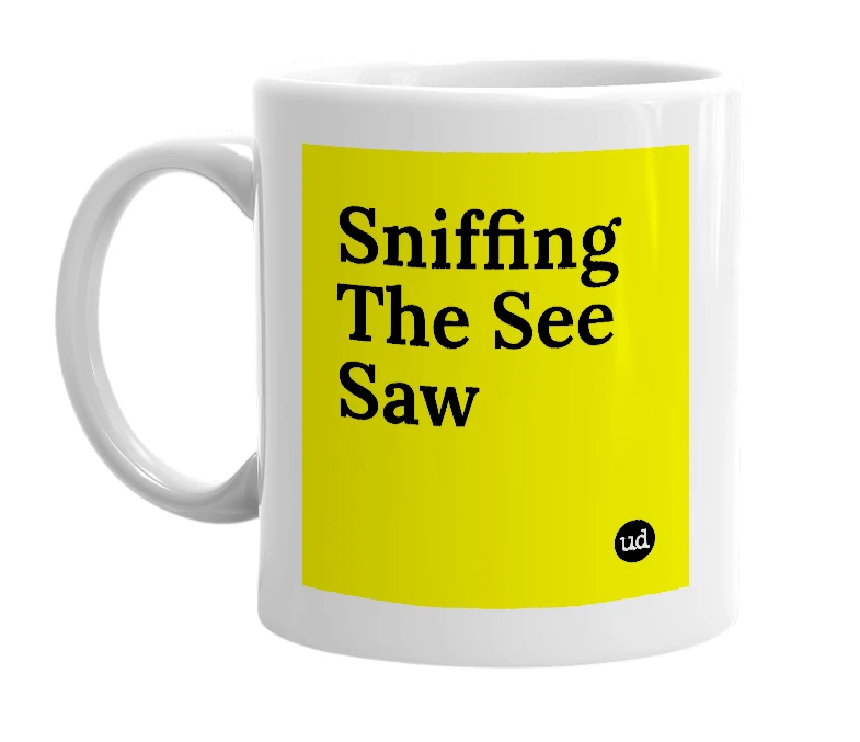White mug with 'Sniffing The See Saw' in bold black letters