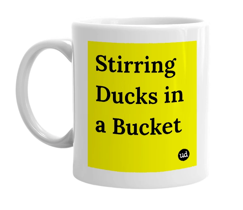 White mug with 'Stirring Ducks in a Bucket' in bold black letters