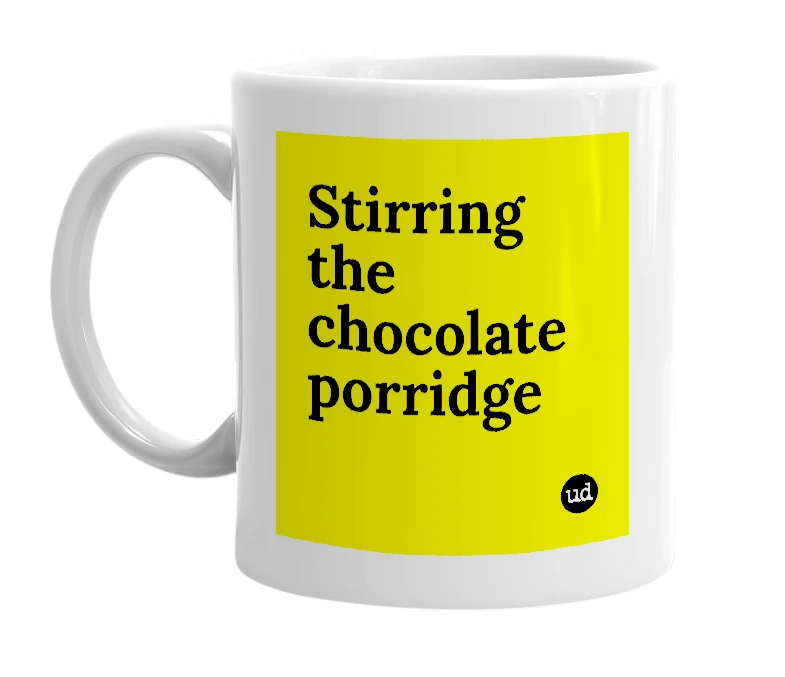 White mug with 'Stirring the chocolate porridge' in bold black letters
