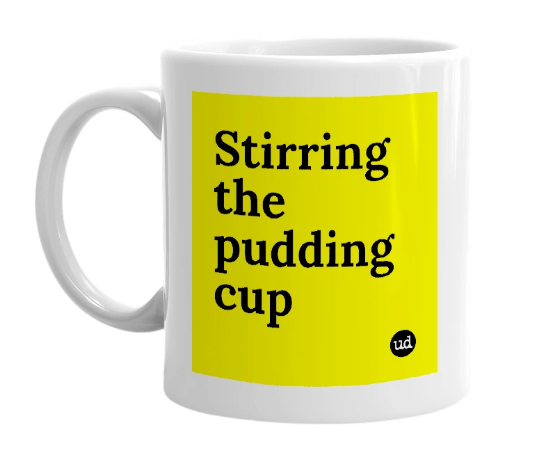 White mug with 'Stirring the pudding cup' in bold black letters