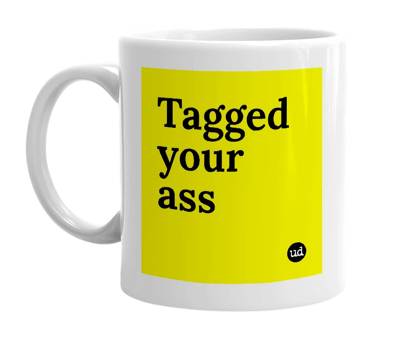 White mug with 'Tagged your ass' in bold black letters