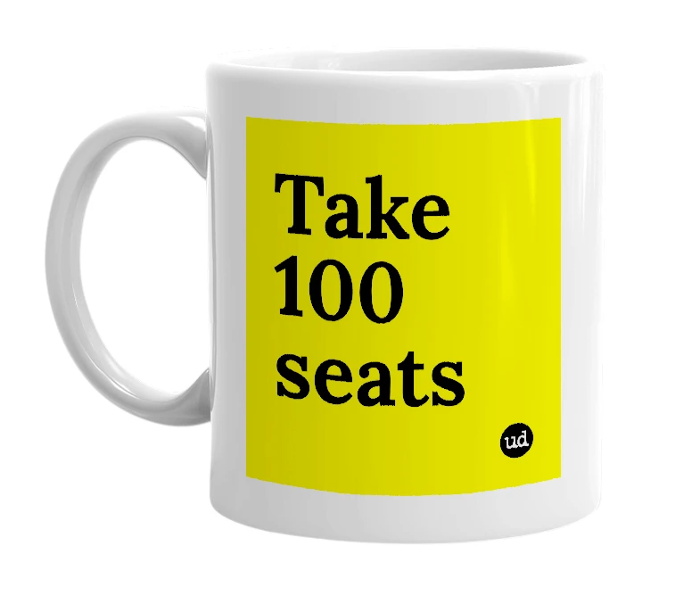 White mug with 'Take 100 seats' in bold black letters