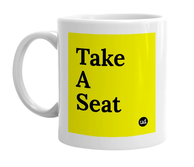 White mug with 'Take A Seat' in bold black letters