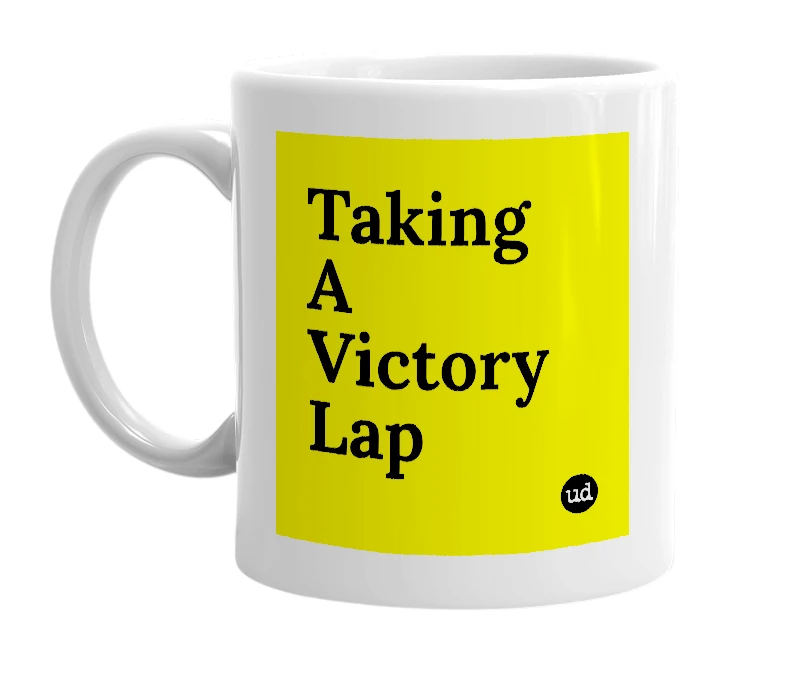 White mug with 'Taking A Victory Lap' in bold black letters