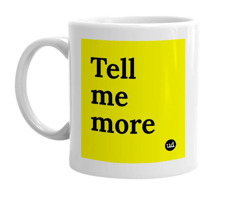 White mug with 'Tell me more' in bold black letters