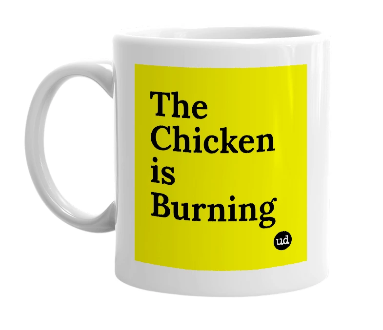White mug with 'The Chicken is Burning' in bold black letters