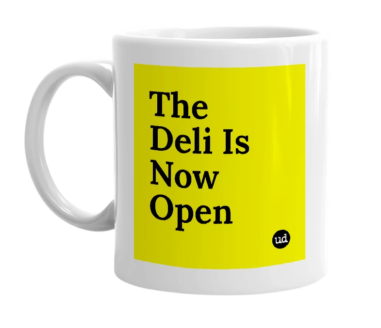 White mug with 'The Deli Is Now Open' in bold black letters