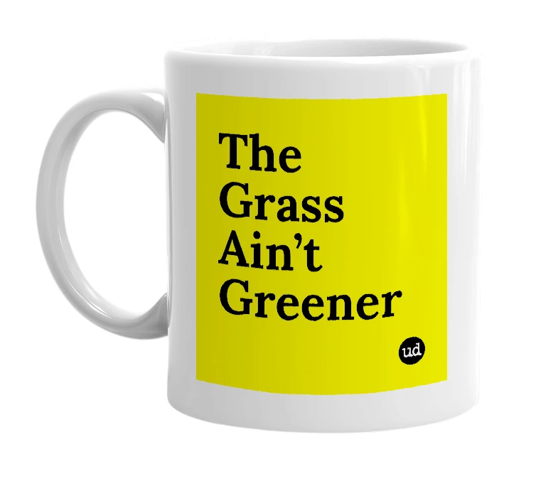 White mug with 'The Grass Ain’t Greener' in bold black letters