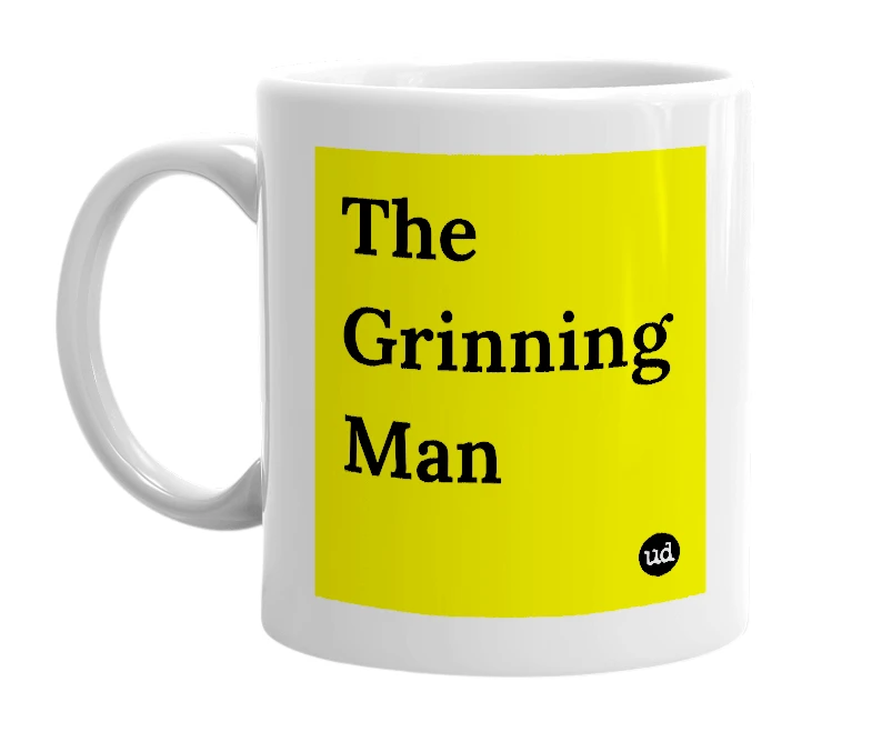 White mug with 'The Grinning Man' in bold black letters