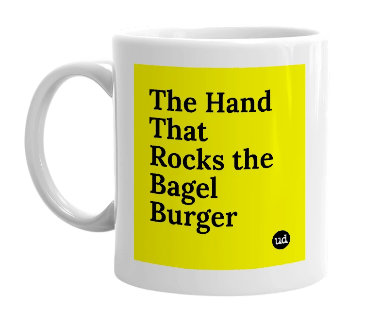White mug with 'The Hand That Rocks the Bagel Burger' in bold black letters