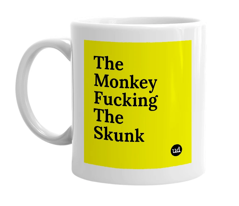 White mug with 'The Monkey Fucking The Skunk' in bold black letters