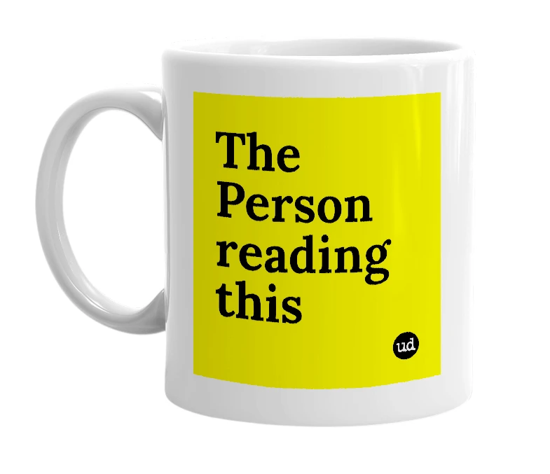 White mug with 'The Person reading this' in bold black letters
