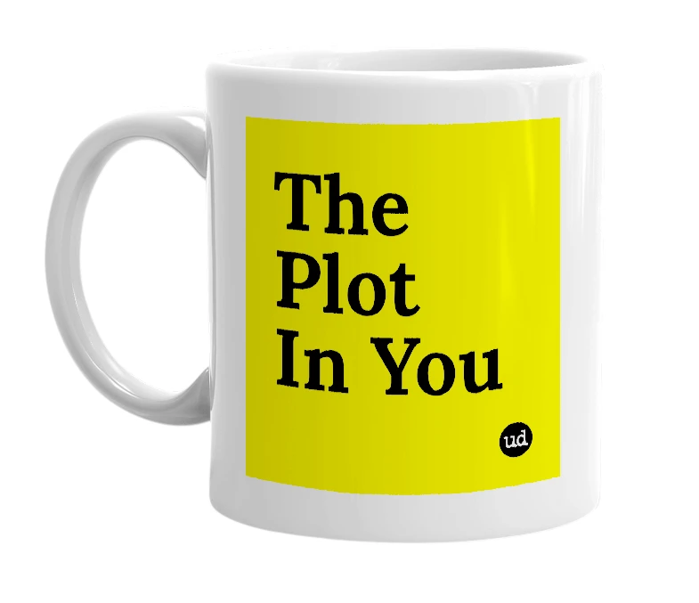 White mug with 'The Plot In You' in bold black letters