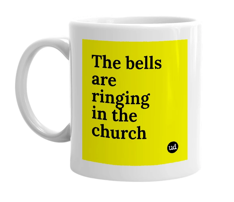 White mug with 'The bells are ringing in the church' in bold black letters