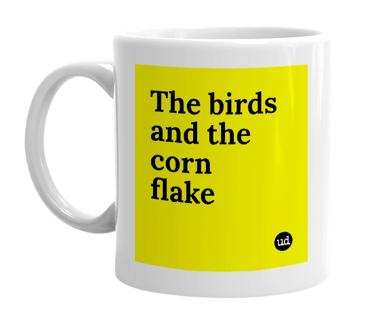 White mug with 'The birds and the corn flake' in bold black letters