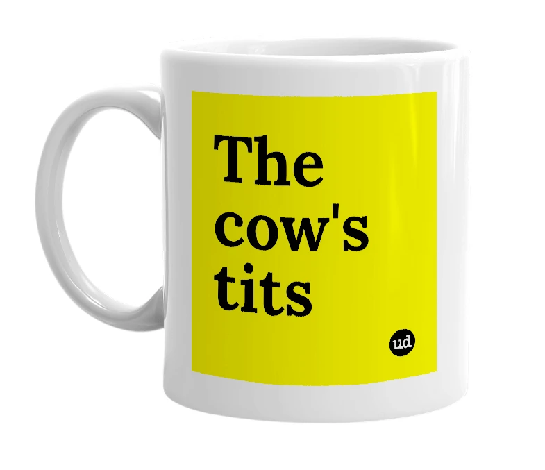 White mug with 'The cow's tits' in bold black letters