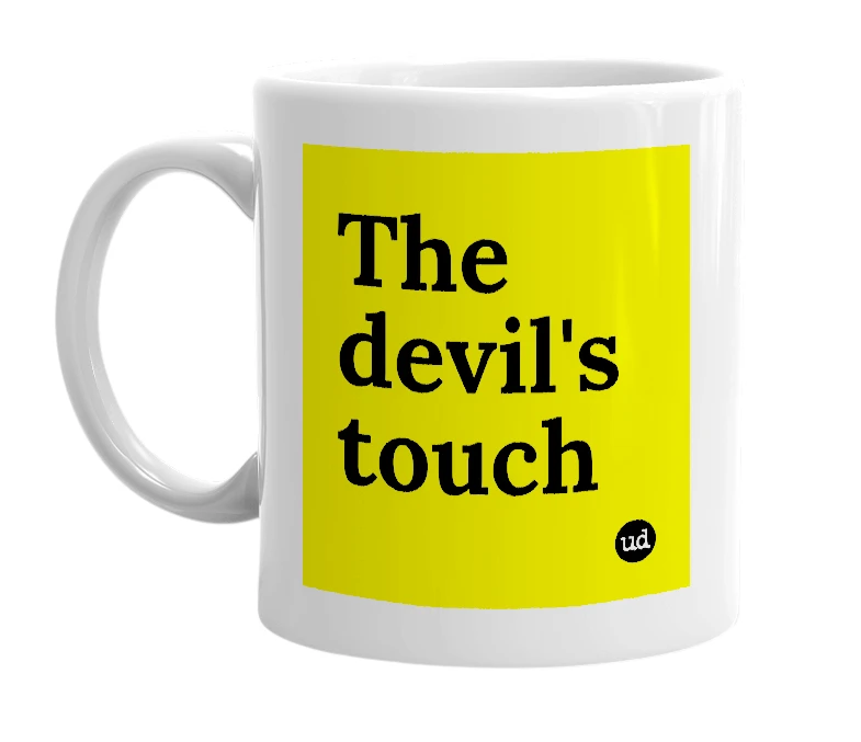 White mug with 'The devil's touch' in bold black letters