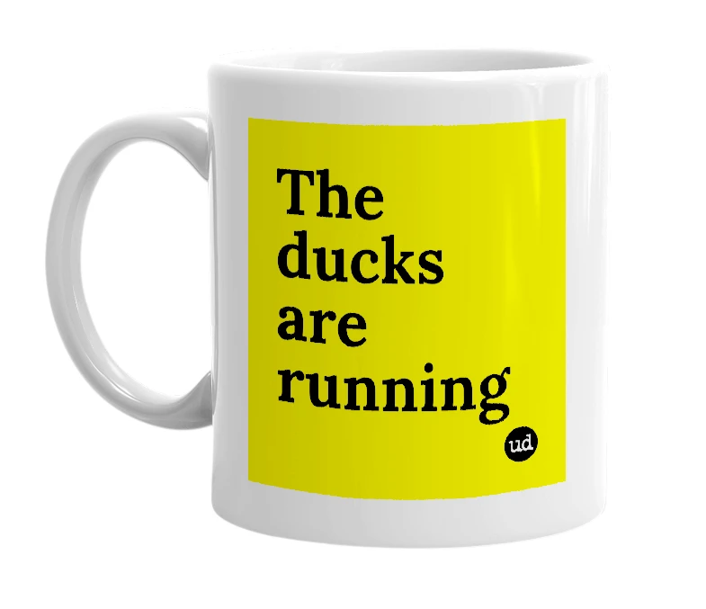 White mug with 'The ducks are running' in bold black letters