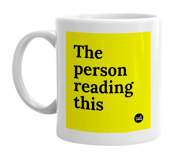 White mug with 'The person reading this' in bold black letters