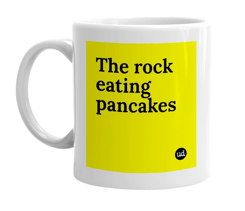 White mug with 'The rock eating pancakes' in bold black letters
