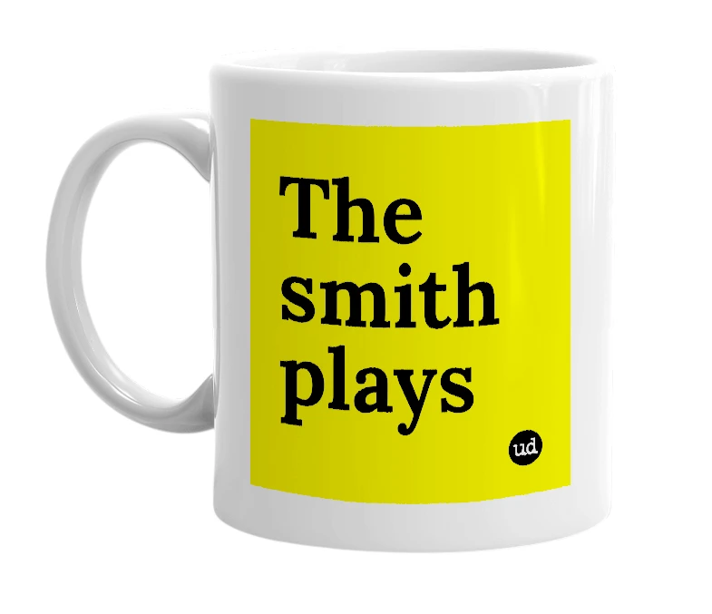 White mug with 'The smith plays' in bold black letters