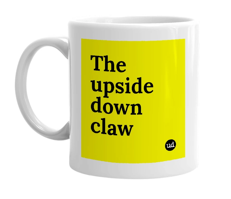 White mug with 'The upside down claw' in bold black letters