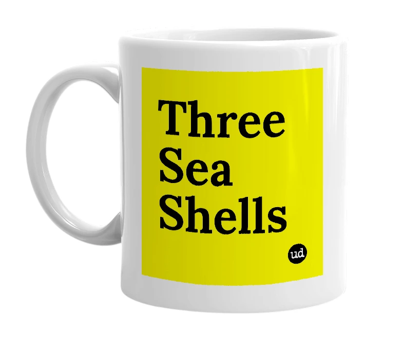 White mug with 'Three Sea Shells' in bold black letters