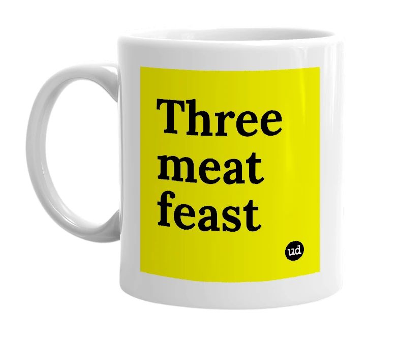 White mug with 'Three meat feast' in bold black letters