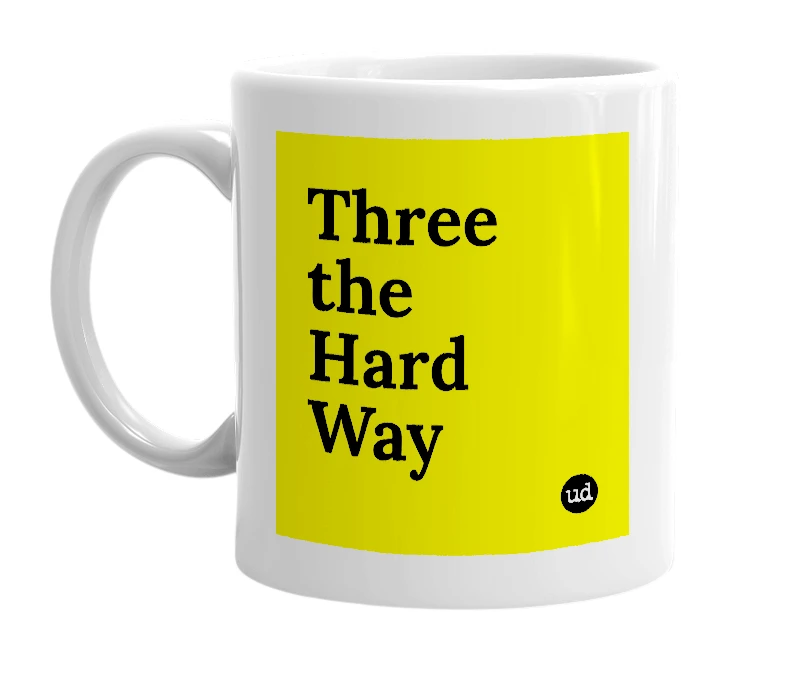 White mug with 'Three the Hard Way' in bold black letters