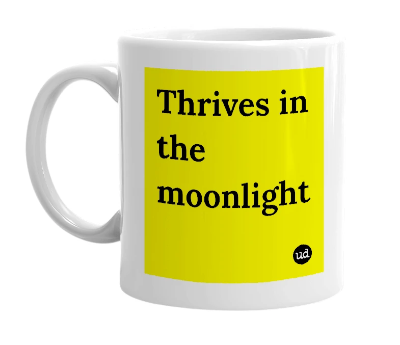 White mug with 'Thrives in the moonlight' in bold black letters